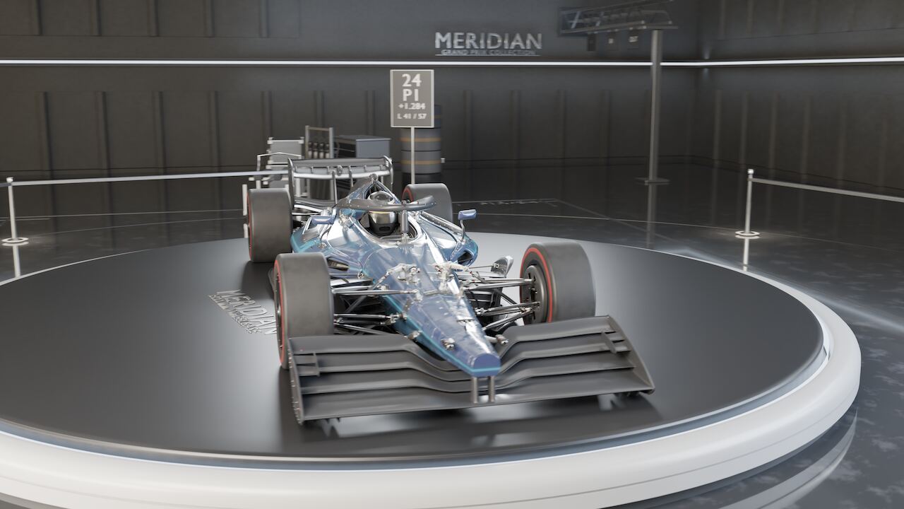 The completed car standing on the lit showroom turntable at the end of the assembly.