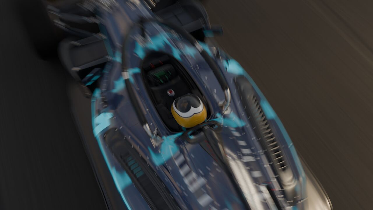 The camera's closest pass of the whole film: the car nearly filling the frame from above, cyan trace livery and the driver's helmet legible.